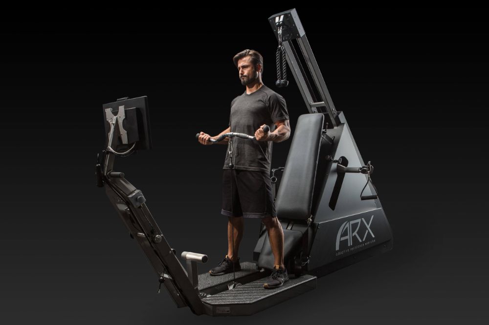 A busy professional training on the ARX adaptive-resistance machine at BioHack Studios in St. Petersburg