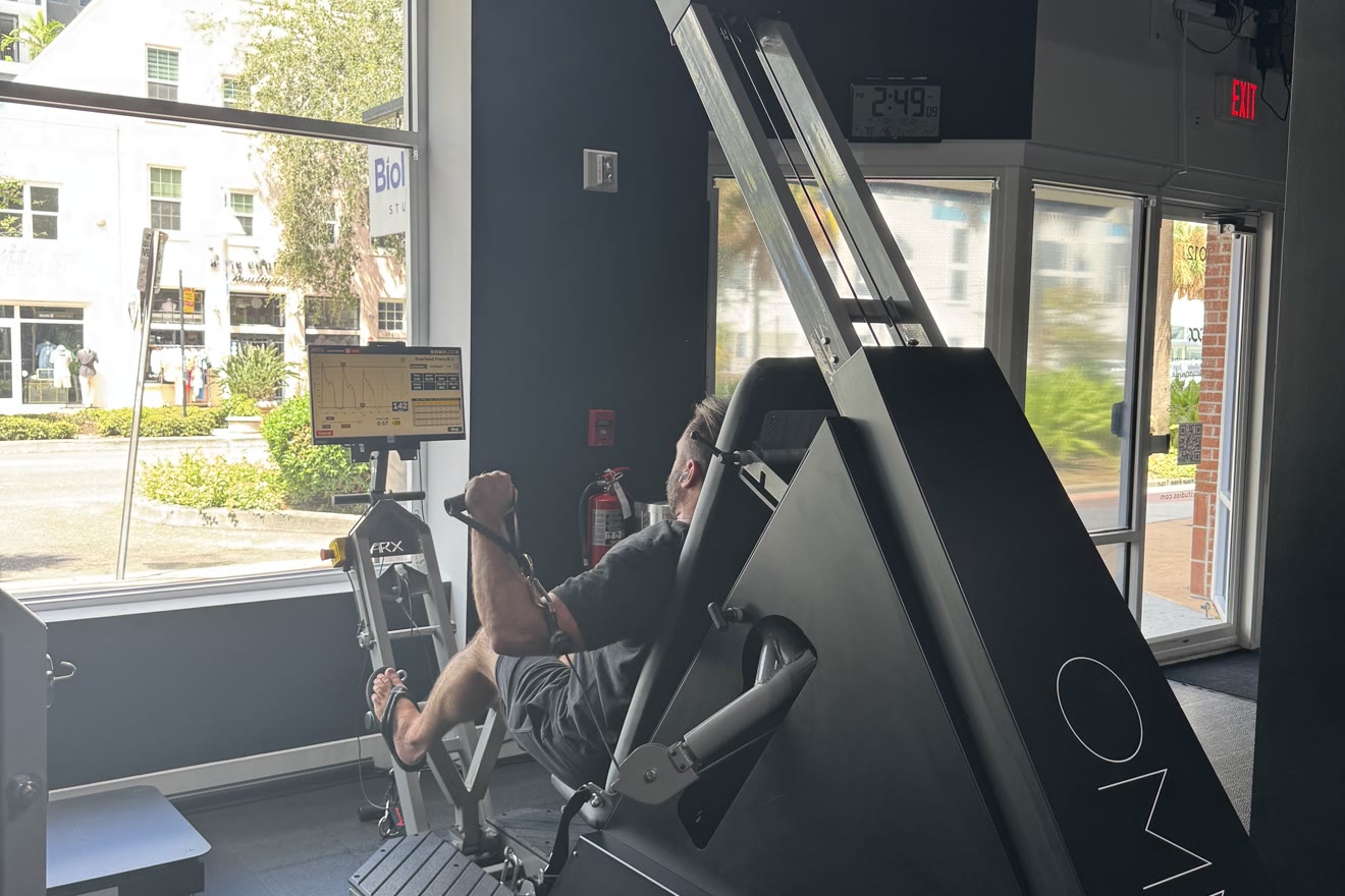 Member training on the ARX Omni machine by the studio window at BioHack Studios