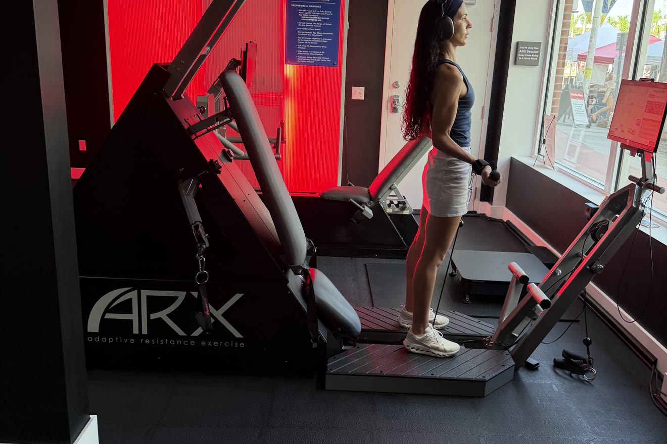 Woman strength training on the ARX machine at BioHack Studios in St. Petersburg