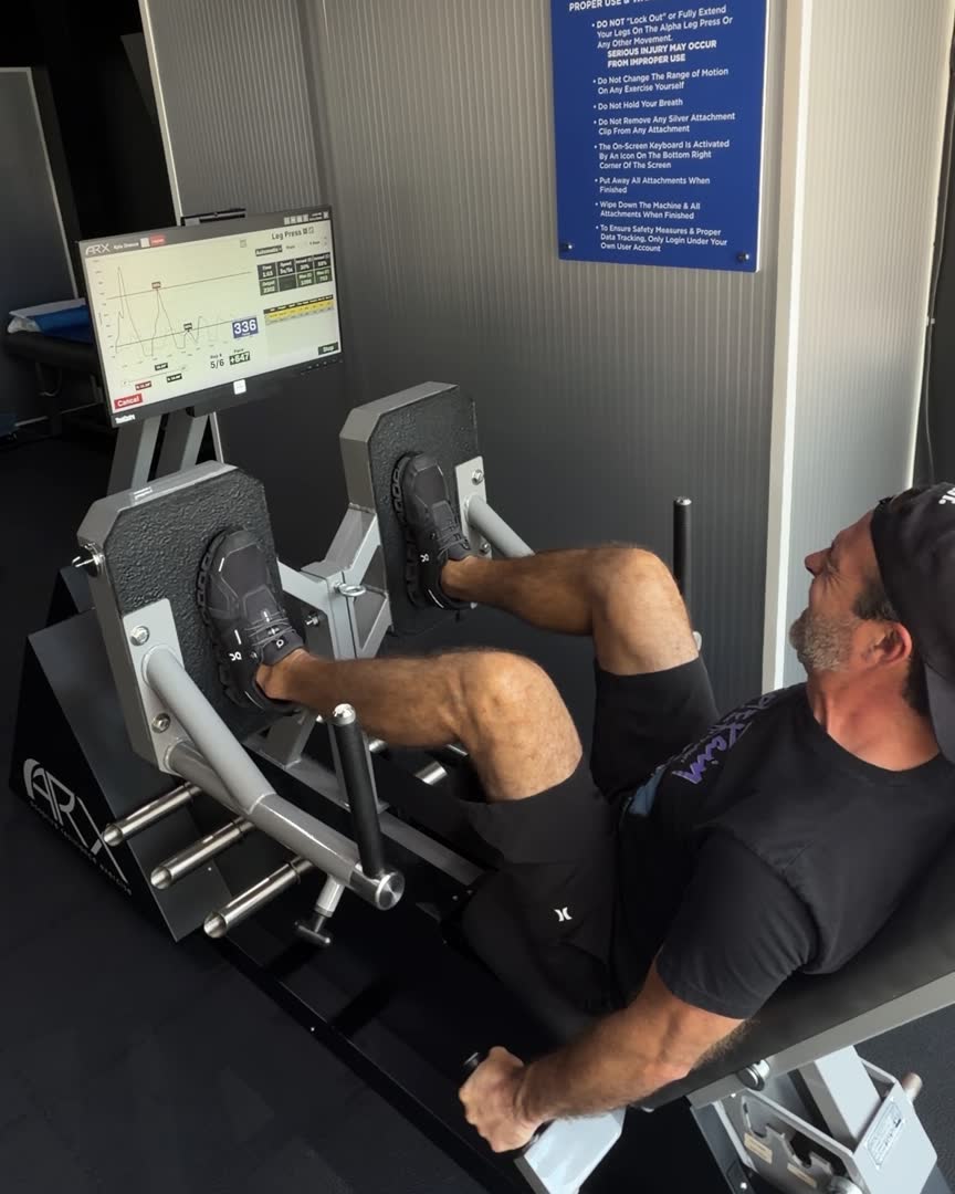 A member training on the ARX adaptive-resistance leg press at BioHack Studios in Downtown St. Petersburg